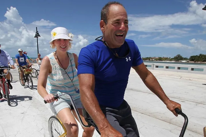 lloyd taking a blind woman on a bike tour